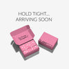 Placeholder image showing Glampton’s pink branded shipping box with the text ‘Hold Tight… Arriving Soon’ above it.