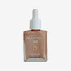 Glampton Golden Hour Glow bronzing drops in a square glass bottle with a white dropper cap on a soft gray background.